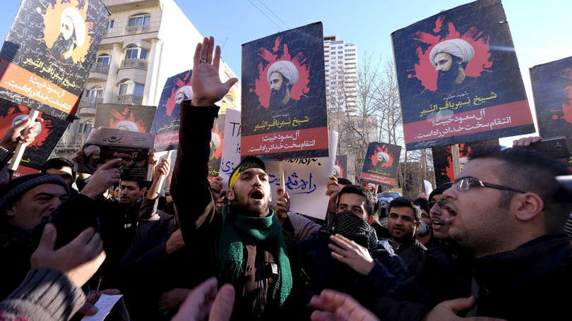 Manifestantes iranianos protestam com fotos do clérigo xiita executado Nimr al-Nimr do lado de fora da embaixada da Arábia Saudita em Teerã.
